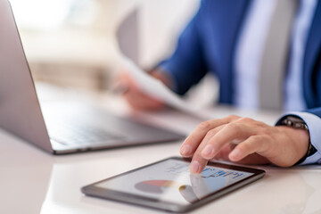 Close up of businessman using tablet