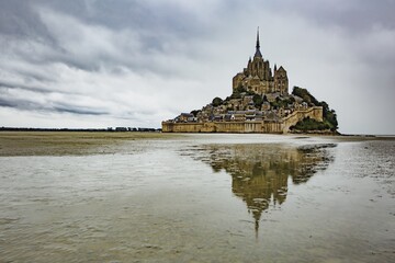 Moody reflection of Mont Saint Michel in France	
