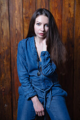 Fototapeta premium Beautiful brunette dressed in denim overalls