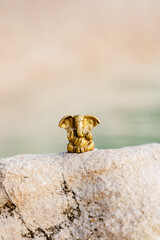 Bronze statuette of the Indian god Ganesha on nature background