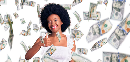 Young african american woman wearing casual clothes doing happy thumbs up gesture with hand. approving expression looking at the camera showing success.