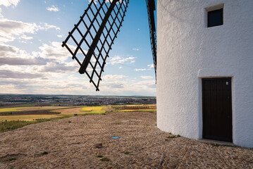 Exterior view of windmills on landscape in spring in Alcazar de San Juan, Ciudad Real, Spain