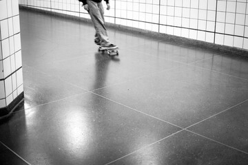 Young person on skateboard in motion blur in the subway.