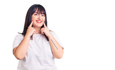 Young plus size woman wearing casual clothes smiling with open mouth, fingers pointing and forcing cheerful smile