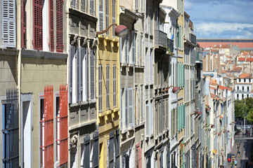 Old houses facades with windows protected by blings and shutters