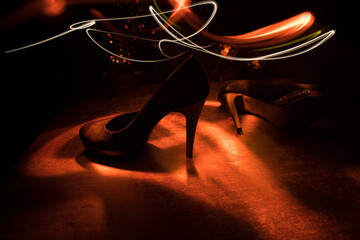 Silhouette of a high heel women shoes at dark. Women power or women domination concept.