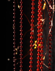 Vertical red Christmas tree garlands. Decoration for Christmas. Ghost lights.