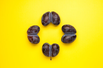 Fused fruits, double prunes. Ugly fruits on yellow background with copy space. Food waste reduction. Using in cooking imperfect products