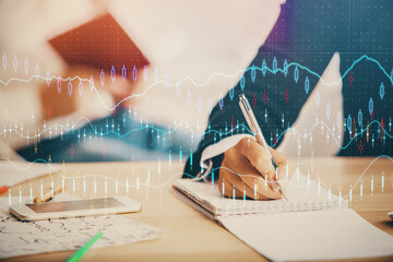Double exposure of forex chart drawing over people taking notes background. Concept of financial...