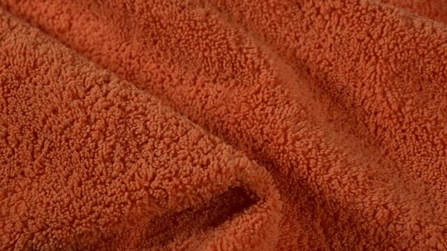 Orange Microfiber Fabric Towel for cleaning and washing house and cars - fabric made from polyester fibers, may consist of polyamide and other polymers.