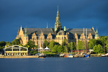 Obraz premium Historic building of gothic style located near water against a post-rain sky