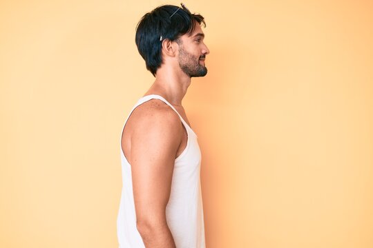 Handsome hispanic man wearing summer look and sunglasses looking to side, relax profile pose with natural face with confident smile.