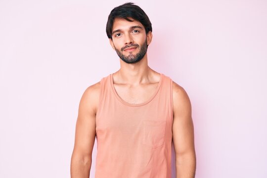 Handsome hispanic man wearing casual clothes relaxed with serious expression on face. simple and natural looking at the camera.