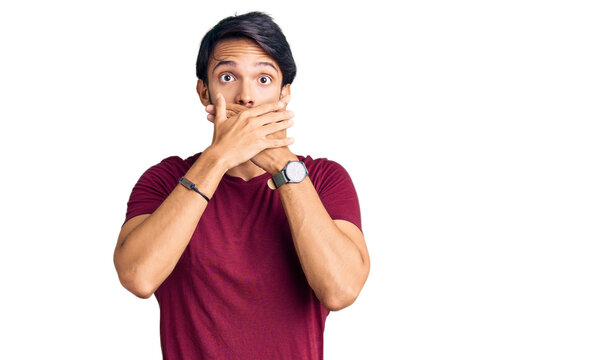 Handsome hispanic man wearing casual clothes shocked covering mouth with hands for mistake. secret concept.