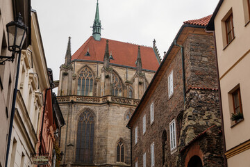Medieval stone St. Bartholomew´s Church, Gothic Cathedral at the end of narrow street in autumn day, arched windows, chimeras and gargoyles, Kolin, Central Bohemia, Czech republic