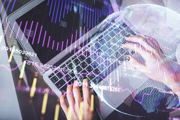 Double exposure of woman hands working on computer and forex chart hologram drawing. Top View. Financial analysis concept.