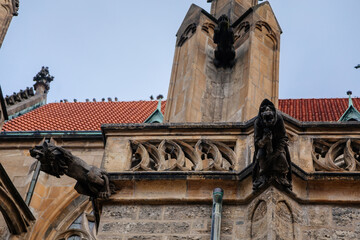 Obraz premium Low angle view at a part of Medieval stone St. Bartholomew´s Church in autumn day, arched windows, chimeras and gargoyles, Gothic Cathedral, Kolin, Central Bohemia, Czech republic