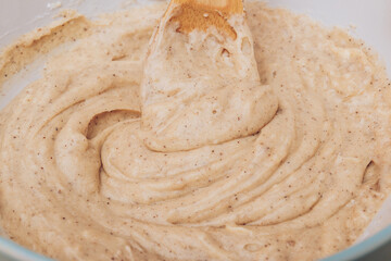 Process of kneading gingerbread dough using wooden scapula. Macro shot.