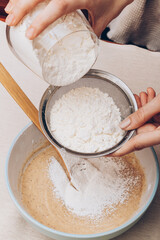 Dough preparation process, mixing of ingredients. Selective focus.