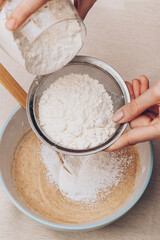 Dough preparation process, mixing of ingredients. Selective focus.