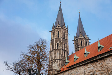 Fototapeta na wymiar Medieval stone St. Bartholomew´s Church in autumn day, arched windows, chimeras and gargoyles, Gothic Cathedral with belfry in Kolin, Central Bohemia, Czech republic