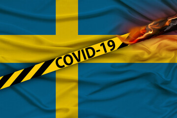 barrier tape with the inscription COVID-19 against the background of the national flag of Sweden, the concept of tourism, quarantine measures, isolation, a ban on entry into the country