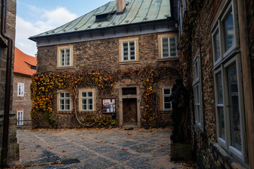 Regional Museum with ivy-covered wall, Dvorak´s Museum of Prehistory or formerly parish school near Gothic Cathedral, Medieval stone St. Bartholomew´s Church, Kolin, Czech republic
