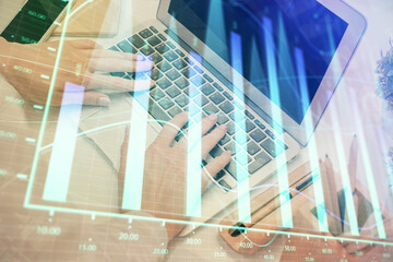 Fototapeta premium Double exposure of woman hands typing on computer and forex chart hologram drawing. Stock market analysis concept.