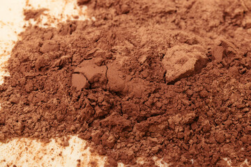 Dough with bunch of cacao on top, close-up. Preparing process to baking. Macro shot.