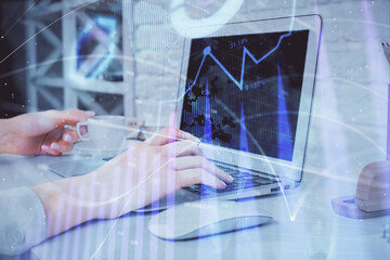 Double exposure of woman hands typing on computer and forex chart hologram drawing. Stock market analysis concept.