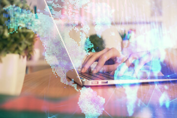 Double exposure of woman hands typing on computer and forex chart hologram drawing. Stock market...