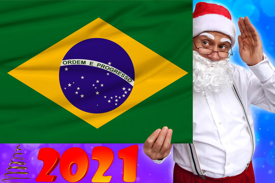 Santa Claus with a beard holds a beautiful colored national flag of the state of Brazil on fabric, concept of tourism, New Year and merry Christmas, economic and political prospects