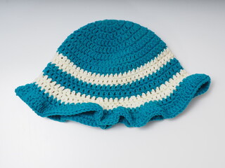 Blue with white strip crochet hat on an isolated background
