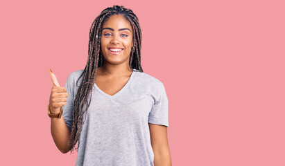 Young african american woman with braids wearing casual clothes smiling happy and positive, thumb up doing excellent and approval sign