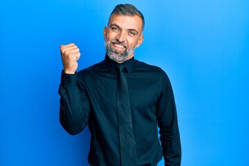 Fototapeta premium Middle age handsome man wearing business shirt and tie smiling with happy face looking and pointing to the side with thumb up.