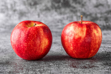 Green and red apples on blackboard or chalkboard background. Bright fruit composition. Close-up on a gray background.