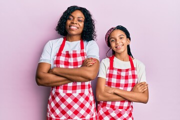 Beautiful african american mother and daughter wearing baker uniform happy face smiling with...