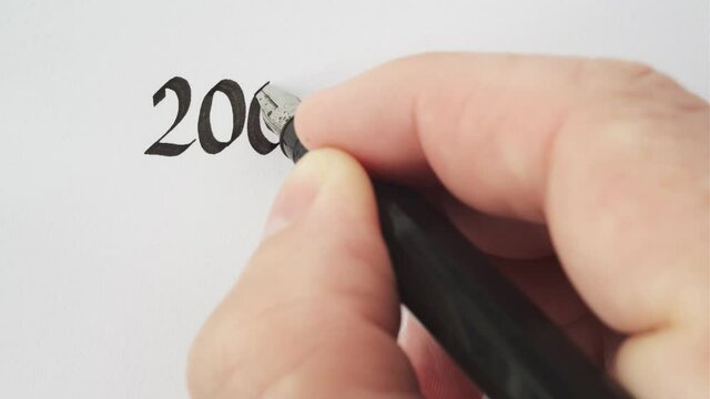 Thank you for 2000 subscriptions, written with a pen. Calligraphy close-up.