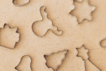 Gingerbread aromatic and spiced dough for Christmas cookies with different shape metal cookie cutters.Preparing Christmas cookies using cookie cutters. Close up view. Baking concept. Top view.