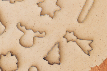 Fototapeta na wymiar Gingerbread aromatic and spiced dough for Christmas cookies with different shape metal cookie cutters.Preparing Christmas cookies using cookie cutters. Close up view. Baking concept. Top view.