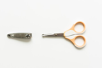Scissors and nail clippers, isolated on white background.
