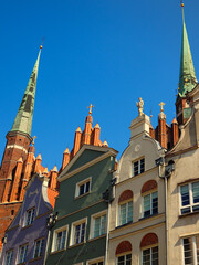 Old colorful tenement houses in Gdansk, against the background of the St. Mary's Basilica.