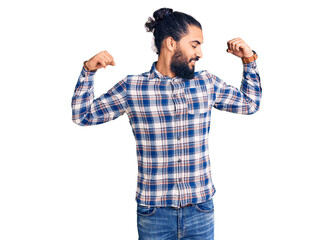 Young arab man wearing casual clothes showing arms muscles smiling proud. fitness concept.