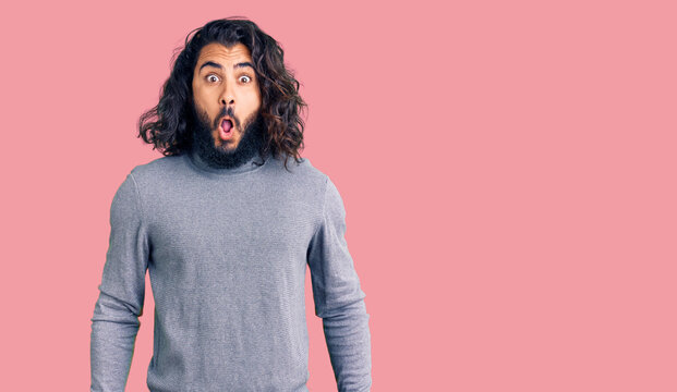 Young arab man wearing casual clothes afraid and shocked with surprise expression, fear and excited face.