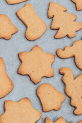 Tasty baked Christmas gingerbread cookies on the white baking sheet.