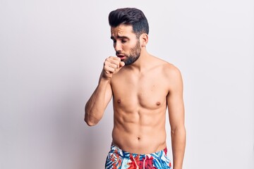 Young handsome man with beard shirtless wearing swimwear feeling unwell and coughing as symptom for cold or bronchitis. health care concept.