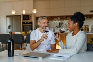 Male and female drinking wine after work.
