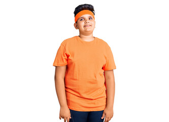 Little boy kid wearing sportswear looking away to side with smile on face, natural expression. laughing confident.