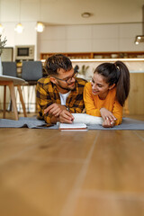 Young couple laughing at home.