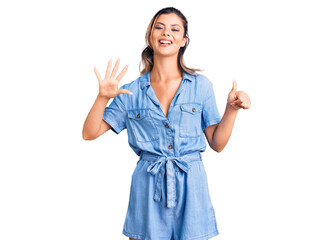 Young beautiful woman wearing casual clothes showing and pointing up with fingers number six while smiling confident and happy.